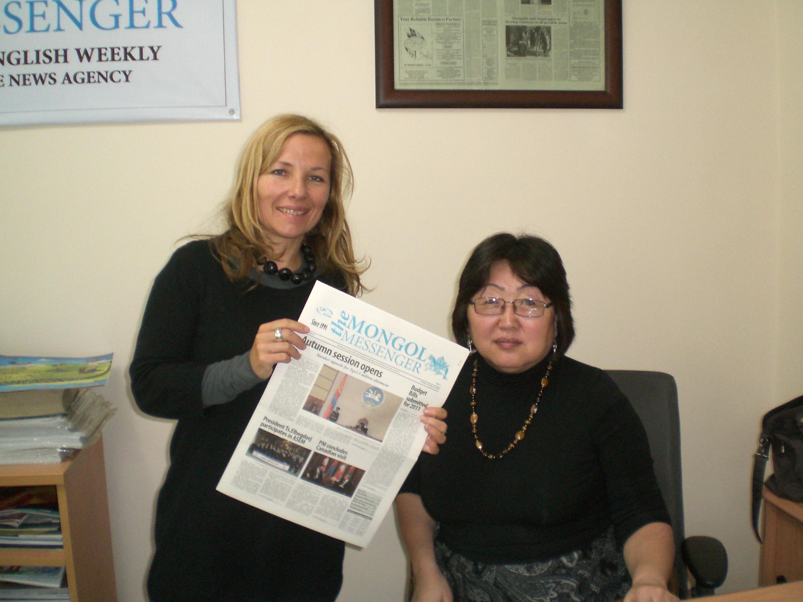 A Projects Abroad journalism intern poses with a supervisor in Mongolia An interns holds up a magazine at her placement in Mongolia